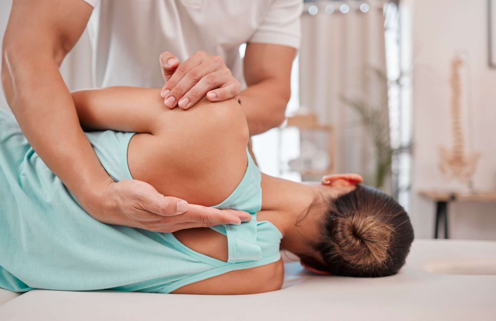 Doctor, chiropractor and woman with back pain for physiotherapy from a physiotherapist helping with